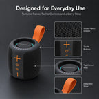 BEEVVOS AC75 wireless speaker detail view showing fabric mesh, control buttons, top panel and orange carry strap.